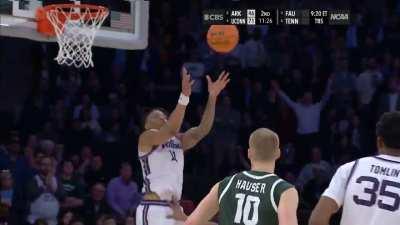 Kansas State's Markquis Nowell having a fake argument with his coach in order to distract his defender and then lobbing it up to teammate Keyontae Johnson who completes the play with a reverse dunk to give them the lead in overtime