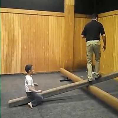 Dad gives son a quick but effective lesson in fulcrum mechanics.