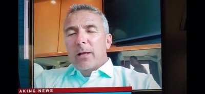 Urban Meyer doing an interview while a guy hits a bong (visible in the mirror). How have I never seen this before?