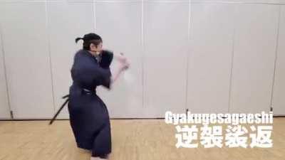 Swordsman demonstrates different Katana strokes