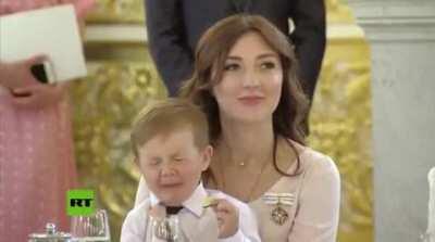 X-post from r/instantregret. little kid eats a lemon at ceremony