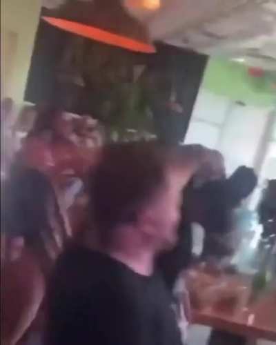 Women twerking at a restaurant.