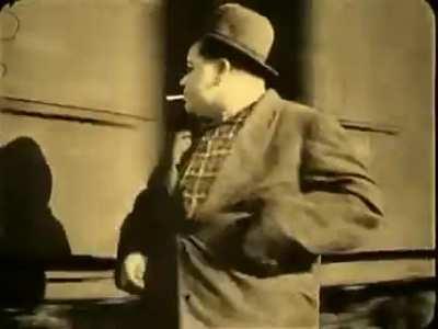 Fatty Arbuckle rolling a cig, striking the match off a moving train, and then hopping on in 1918