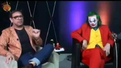 The TV presenter gets scared when the joker offers alcohol gel