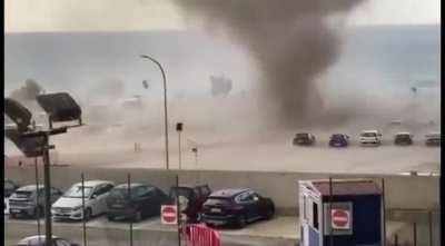 Waterspout hits land and becomes a tornado.