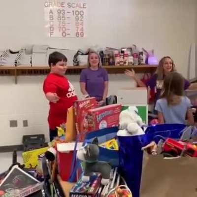 Students surprise a boy with toys after he lost all of his in a fire