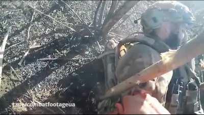 Footage of a small arms battle from a Ukrainian soldier's GoPro. One of the soldiers was wounded but continues to fire his machine gun. September 2023, the exact location is unknown.