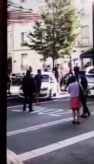 Players of a French rugby team move a car that blocks the way of their bus