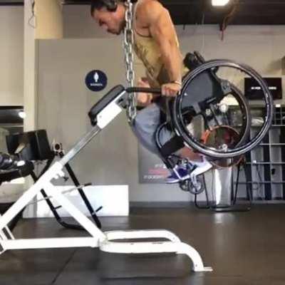 This guy pulling his entire body + a wheel chair only using his arms