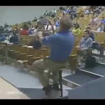 Physics professor demonstrating conservation of angular momentum