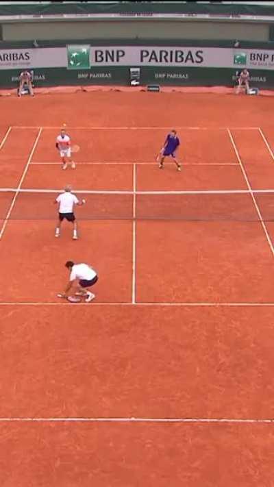 This man lost control of the raquet in the middle of the match and he used his hand