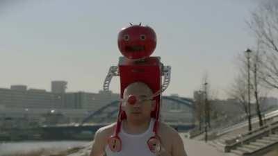 Tomatan, a wearable robot that feeds you tomatoes as you run.