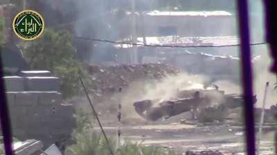 SAA tank fires straight at camera, projectile visible. [Syria, 2013]