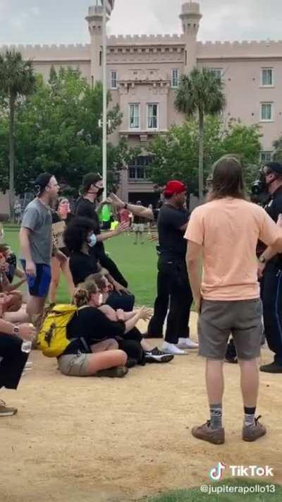 Police arresting a peaceful protestor for simply speaking to them.