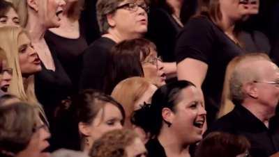 Choir mimics thunderstorm then performs “Africa” by Toto.