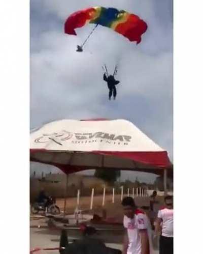 Parachuter almost hit the crowd