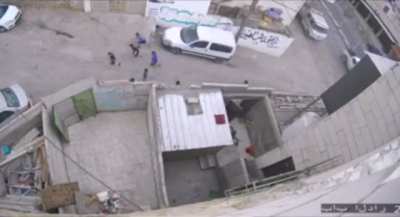 An Israeli soldier chases Palestinian children in the neighborhood of al-Harya in occupied Al-Khalil. (Source: Quds News Network)