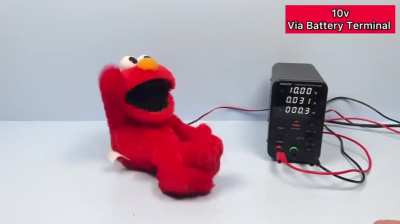 An Elmo toy under increasing voltage