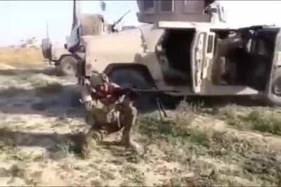 Iraqi Machine Gunner tries be Rambo but gets shot in the shoulder.