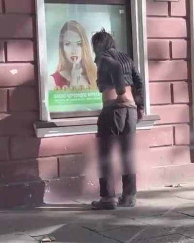 Guy anoints window advertisement with swamp ass