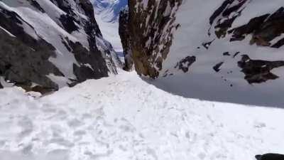 Travis Rice gliding along the mountains