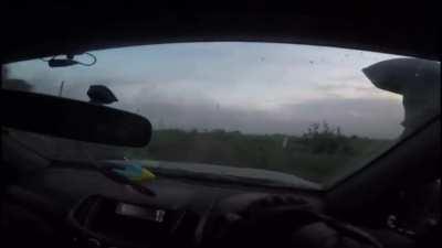 Ukrainian soldiers POV as they drive a light skinned vehicle out of what looks like Bakhmut under heavy fire. 2023