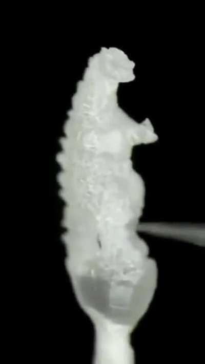 A micro Godzilla made from a single grain of rice