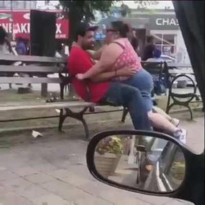 Couple in a heated meeting in a public square.