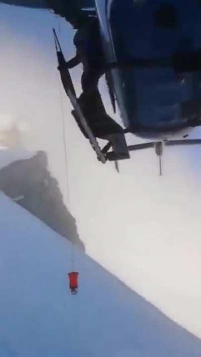 French helicopter unit arrives within minutes 7000 feet up a dangerously windy mountainside, gets inches from the snowy slope on emergency call by injured skiers