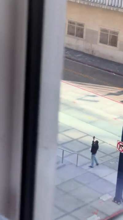 Man yelling to the wind (and central court house in San Diego,CA)