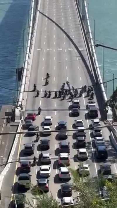 Bikers block traffic to perform their stunts 