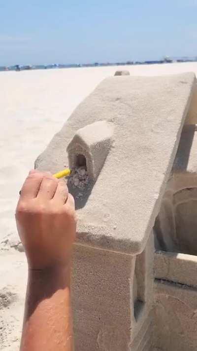 Making a sand sculpture.