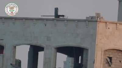 FSA fighters observe a wheeled rooftop MG position, then engage it with a &quot;Hell Cannon&quot; round - 6/3/2014 - Aleppo