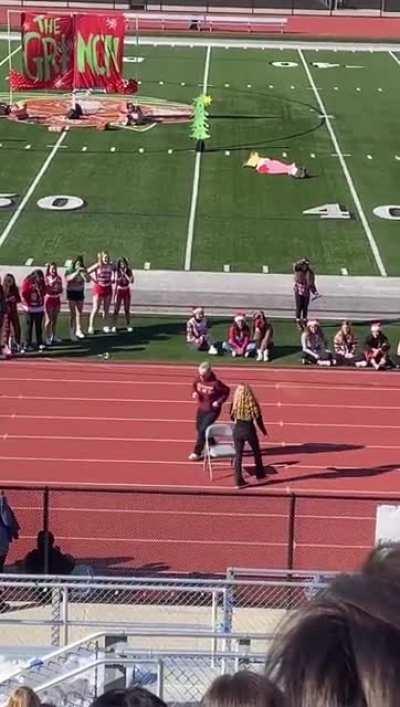 Teacher and student compete in a end of the term musical chairs session (El Modena High School, Orange County, CA)