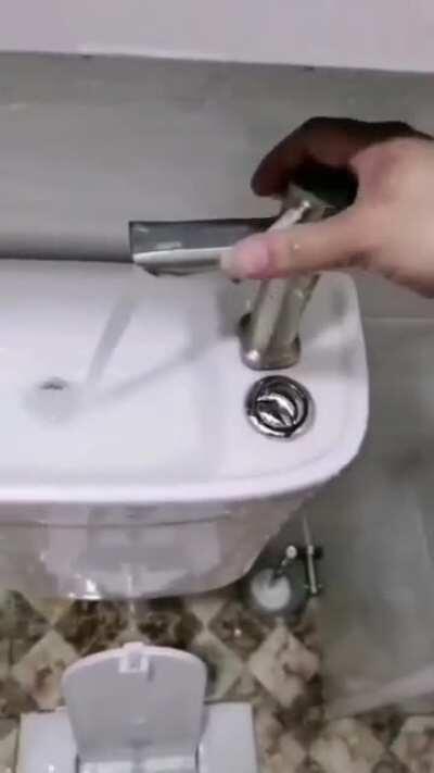 Toilet and Sink combo. Flushing the toilet with water from the sink.