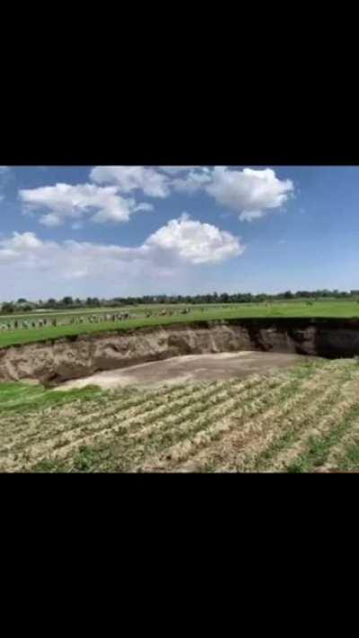 A massive sinkhole opens up in an unknown location