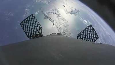 View from a camera on Space X Falcon 9 during liftoff with stage 1 returning to the ground in 90 seconds