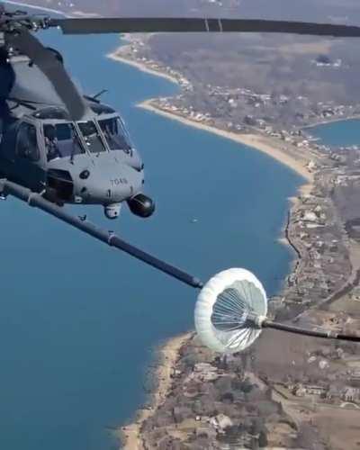 Helicopter refueling in mid air.