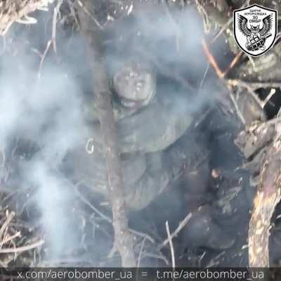 Two russian soldiers in a trench try to fight drones in vain