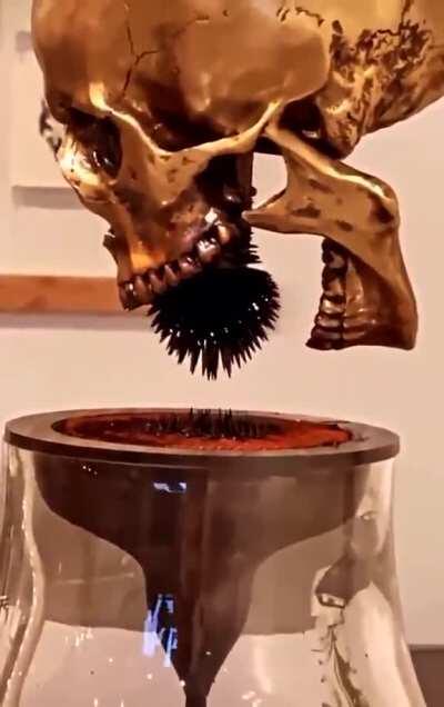 This Metallic Art Sculpture Of A Skull Uses Ferrofluid For Visual Effect