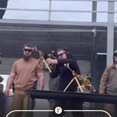 This is russia. Kadyrov junior is firing two gold plated machine guns. 