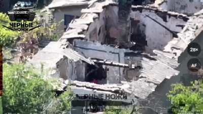 Russian troops of the Black Knives division raise their flag over ruins in the village of Zavetnoe - September 2024