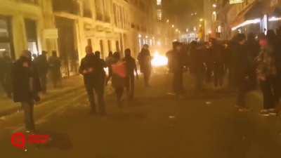 Paris tonight after Macron used a constitutional power to pass controversial law about the retirement age without a parliament vote.