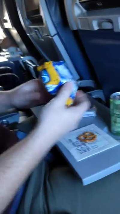 Enjoying a snack on an airplane