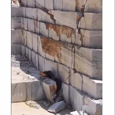 The scale of this marble quarry is so huge that it makes the excavator look like a toy