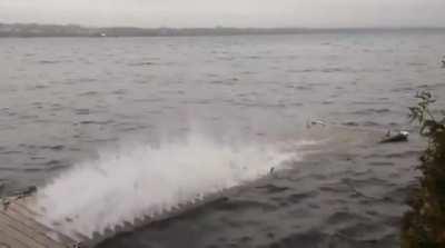 Waves shooting through dock