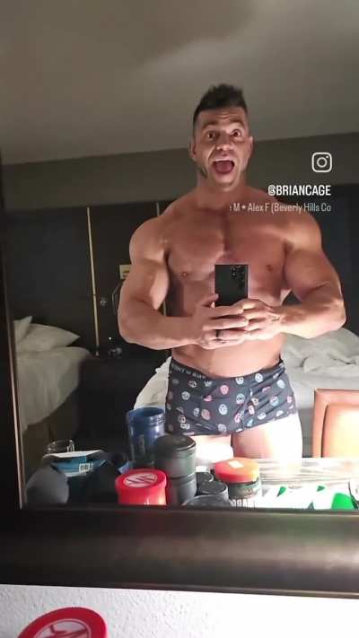 Brian Cage pec flexing in his undies