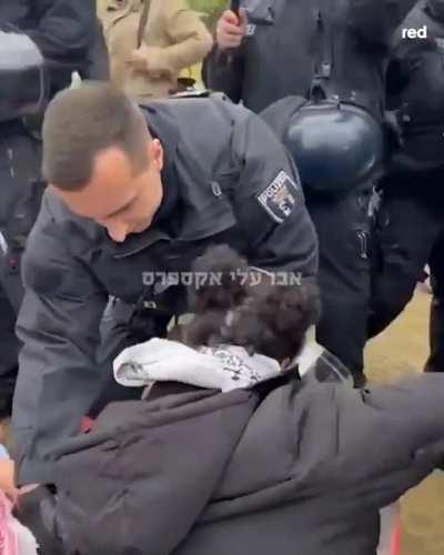 German police evict Kafiya-wearing protesters participating in an anti-Israeli demonstration in front of the German Parliament.