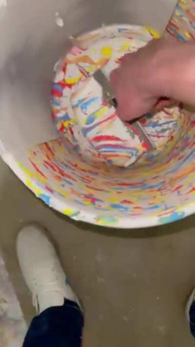 Scraping a paint bucket