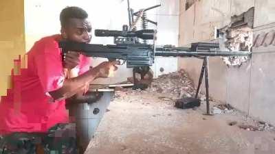 Sudanese soldier with an anti-materiel rifle and a machinegun firing on RSF forces